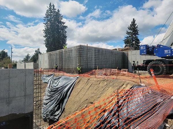 a concrete retaining wall aboe a steep drop off