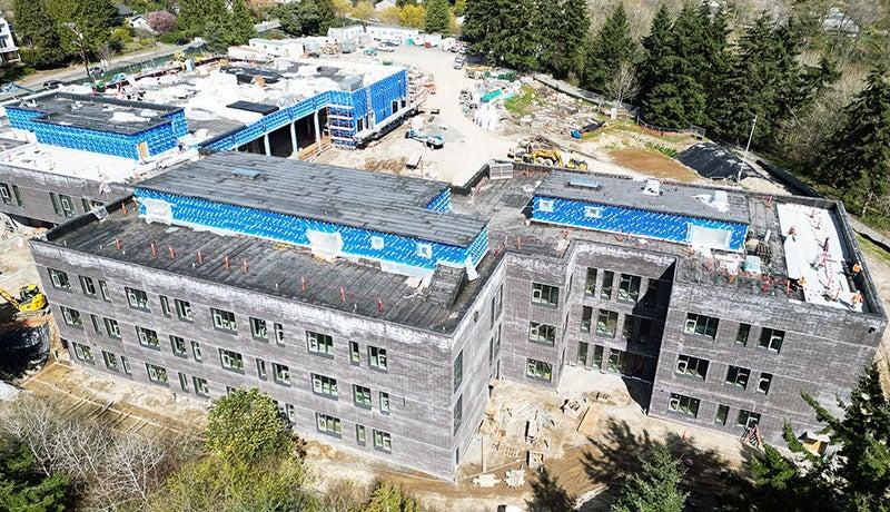 aerial view of a 3 story building with dark brick